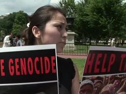 2009 MS TU TD Female protestor, shouting slogans and holding posters during an anti-China protest in support of the Uygurs/ Washington D.C., USA/ AUDIO Stock Footage