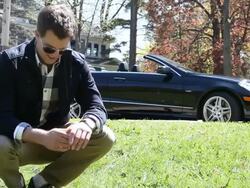 MS Young man smiling in park next to his modern car on asunny day / Minneapolis, Minnesota, United States Stock Footage