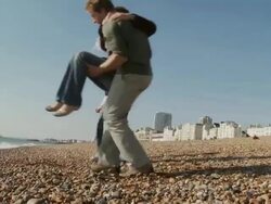 MS, Family with two children (10-11, 12-13) playing on Brighton beach, rear view, Brighton, Sussex, United Kingdom Stock Footage