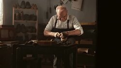 HD DOLLY: Elderly Shoemaker Sewing The Vamp Stock Footage