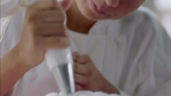 Pastry chef puts finishing touches on gourmet cake Stock Footage
