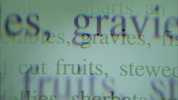 Printed food items and ingredients scroll over other cooking and informational text. Stock Footage