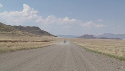 A safari jeep drives through the Namib Desert. Stock Footage
