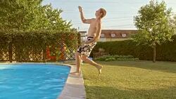 SLO MO TS Young man doing backflip into the pool Stock Footage