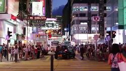 HONG KONG - JULY 2015: Pedestrians cross the street in downtown Hong Kong, China Stock Footage