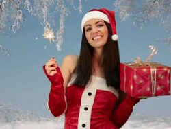 girl in red santa hat holding Christmas Present Stock Footage