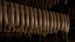 A door closes in front of a rack of sausage links. Stock Footage