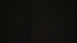 Fireworks explode behind a tower at night. Stock Footage