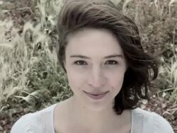 Young woman in grassy field, close up Stock Footage