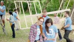 Volunteers carrying wood planks at construction site Stock Footage
