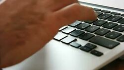 Hand typing a laptop computer Stock Footage