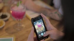 Young woman uses smartphone app to take a photo of cocktail drink and apply filters Stock Footage