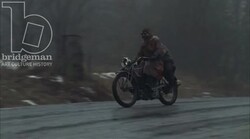 Man and boy riding on a motorbike, 1930s - reenactment Stock Footage