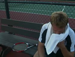 MS, Distressed young man sitting on bench at tennis court, Santa Barbara, California, USA Stock Footage