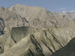 WS View of Arid mountains and snowy peaks / High Himalayas, Upper Dolpo near Tibetan border, Nepal     Stock Footage