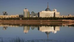 Central Asia, Kazakhstan, Astana, View of city reflecting in Isahim River and Ak Orda Presidential Palace Stock Footage