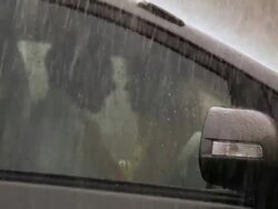 Young couple romancing in a car in rain season, Delhi, India Stock Footage