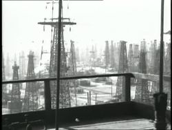 Oil derricks pump in a Texas field. News Clip