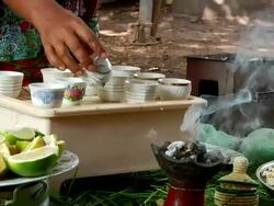 Ethiopian woman pours coffee Stock Footage