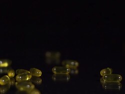 HD SLOW MOTION: Cod Liver Oil Capsules Stock Footage