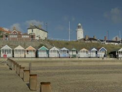 Southwold,colourful beach huts,People walking on promenade,,Lighthouse,MS,PAN Stock Footage