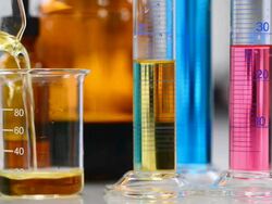 Pouring yellow liquid into Beaker Stock Footage