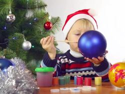 boy paints Christmas balls Stock Footage