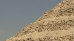 The ancient Saqqara Pyramid contrasts against a pale blue sky. Stock Footage