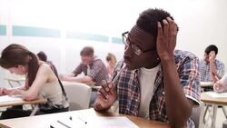 Pensive boy taking test in classroom Stock Footage