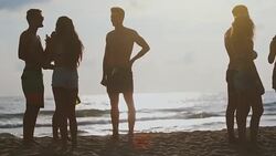 Summer vacation with friends: beach party at sunset Stock Footage