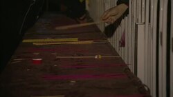 Celebrants lay sticks of colored incense onto an altar. Stock Footage