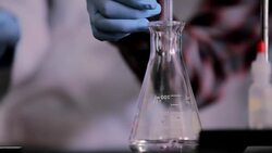 Hands of students conducting lab experiment Stock Footage