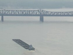 WS Tugboat moving coal filled barge towards Memphis Arkansas bridge / Memphis, Tennessee, United States Stock Footage