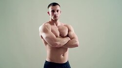 healthy athlete  with nice muscle on grey  background Stock Footage