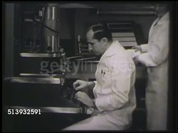 1952: MICROBIOLOGY LABORATORY:  VS Two microbiologists operating electron microscope in lab. Microscopic organisms, microorganisms, science, biology, infectious diseases, medical research Instructional Video