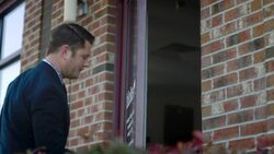 Small business owner unlocks door to clothing store in the morning Stock Footage