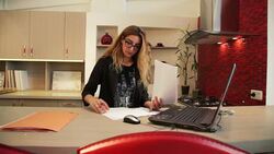 Woman Designer working on laptop in the kitchen Stock Footage