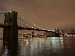 Timelapse of the Brooklyn Bridge at night with flowing river. Stock Footage