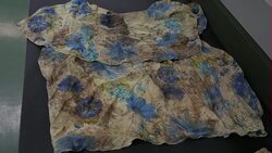 Lab workers examining clothes of dead migrants News Clip