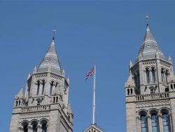 THE NATIONAL HISTORY MUSEUM UNION JACK FLAG POLE Stock Footage