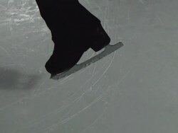 Close Up, Locked Down - Blades of a figure skater lands on the ice after a jump / USA Stock Footage