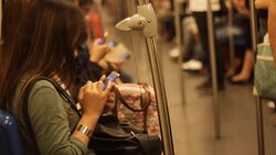 Crowded people in the mass public transportation using their phone while waiting Stock Footage