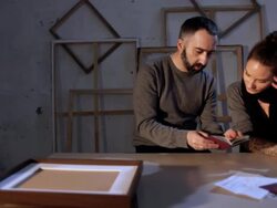 Art forger and artist looking at forged documents, dolly Stock Footage