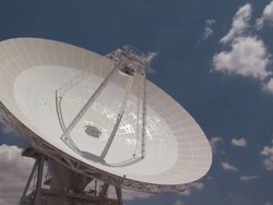 Low Angle static _ Clouds drift over a radio telescope dish / Fort Irwin, California, USA Stock Footage
