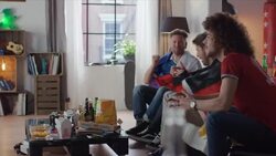 Sport fans sitting on couch watching tv and cheering Stock Footage