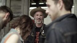 Customers chat with friendly Texan shop vendor at outdoor market Stock Footage