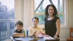 Mother helping children with homework Stock Footage