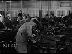1947 CLEVELAND HIGH SCHOOL: OHIO: VS Male instructor overlooking males in workshop operating machinery. VS Male teacher looking over female students sitting at desks w/ typewriters. OH Instructional Video
