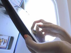 Woman using digital tablet on airplane Stock Footage