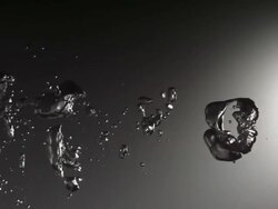 CU SLO MO Shot of large silver colored bubbles move from right frame to left / United Kingdom Stock Footage